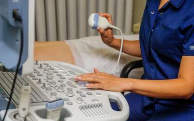 Diagnostic Medical Sonographer working in healthcare setting